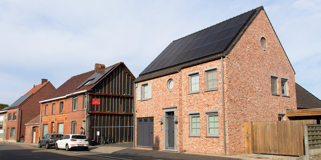 Vooraanzicht van prachtige villa met zonnepanelen op het dak.